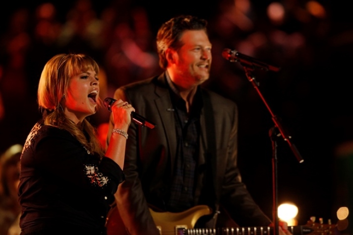 Holly Tucker, a contestant on NBC's 'The Voice' sings with country music star Blake Shelton at the 'Healing in the Heartland: Relief Benefit Concert' in Oklahoma City, Okla., on May 29, 2013.
