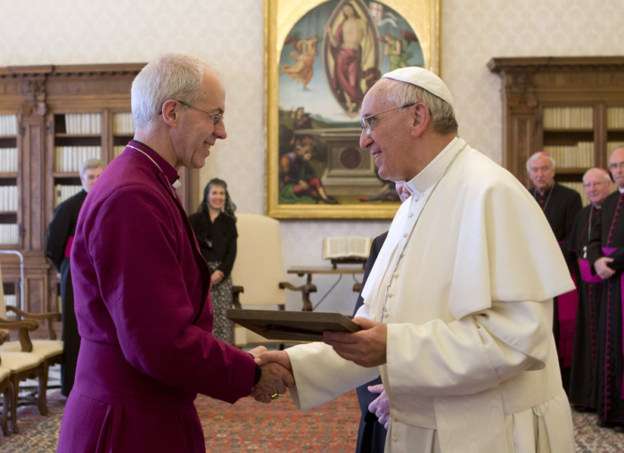 Pope Francis (R) exchange gifts with the Archbishop of Canterbury Justin Welby during a private audience at the Vatican June 14, 2013.