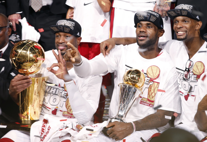 Miami Heat's Dwyane Wade (L), LeBron James (C) and Chris Bosh celebrate winning the NBA Championship following Game 7 of their NBA Finals basketball playoff against the San Antonio Spurs in Miami, Florida June 20, 2013.