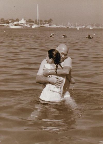 On a Facebook group paged dedicated to praying for Pastor Chuck Smith of Calvary Chapel Costa Mesa, Calif., who has lung cancer, Judy Di Lulo (Caggegi) posted a photo, taken by her father, of her being baptized by Smith in the bay off Corona Del Mar Beach. Along with the photo, she wrote, 'I am 43 now, this was me at 18. Pastor Chuck baptized me and it is so special to me. Praying for you Papa Chuck, Judy Caggegi.'