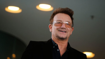 Bono, lead singer of the band U2 and ONE organisation co-founder arrives for a reception with German Chancellor Angela Merkel and with youth representatives of the organisation ONE against human poverty in Berlin April 8, 2013. ONE is a grassroots advocacy and campaigning organization that fights extreme poverty and preventable disease, particularly in Africa.