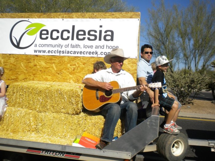 Pastor Steve Gilbertson (with guitar) and members of the Ecclesia Church participate in the Cave Creek Fiesta Days Rodeo Parade in Cave Creek, Ariz.