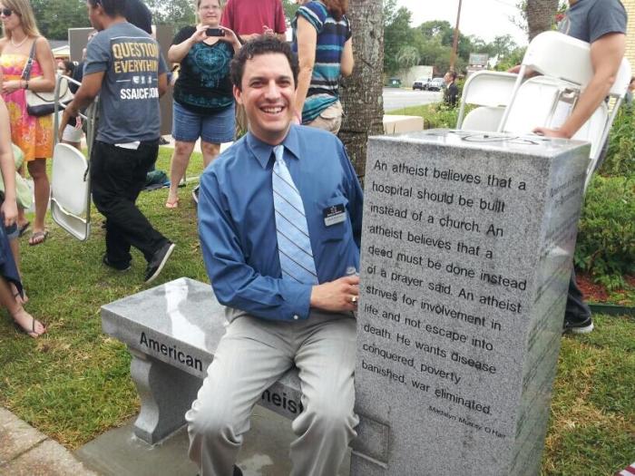 David Silverman, president of American Atheists, seated at a monument bench unveiled and dedicated on June 29, 2013 at the Free Speech Forum at the Bradford County Courthouse, Fla.