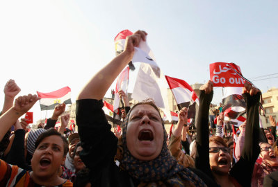 Protesters against Egyptian President Mohamed Mursi shout slogans during a demonstration in front of the presidential palace in Cairo July 3, 2013. The Egyptian president's national security adviser said on Wednesday that a 'military coup' was under way and army and police violence was expected to remove pro-Mursi demonstrators.