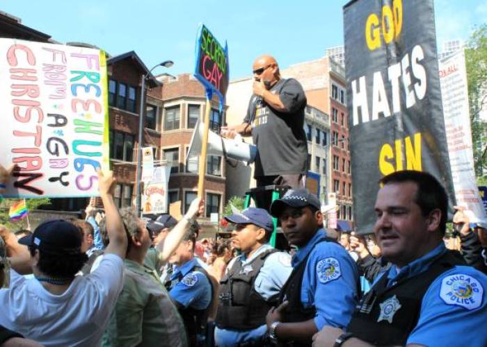 Ruben Israel (center) and members of Bible Believers surrounded by Chicago Police officers during a protest in Chicago, Ill., on June 30, 2013.