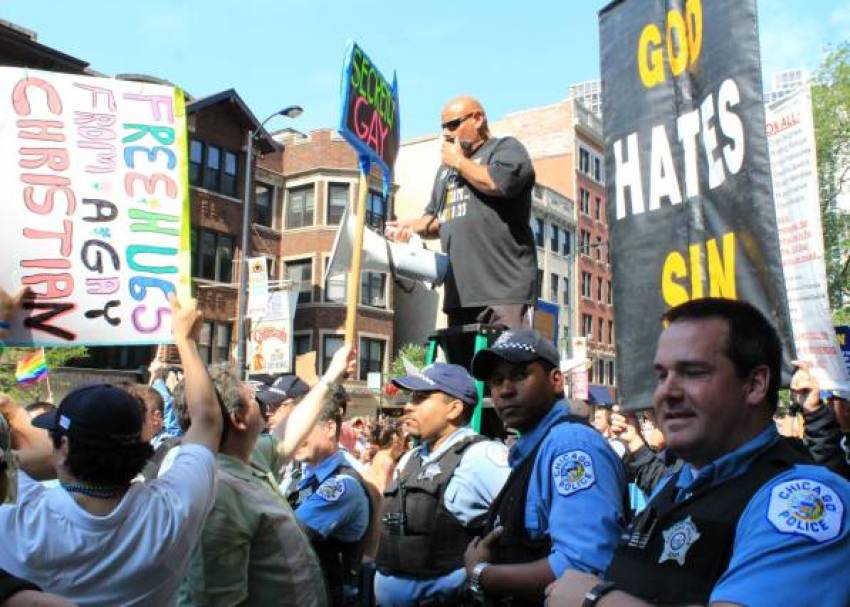 Ruben Israel (center) and members of Bible Believers surrounded by Chicago Police officers during a protest in Chicago, Ill., on June 30, 2013.