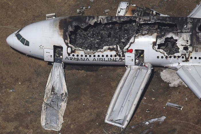 An aerial view of an Asiana Airlines Boeing 777 plane is seen after it crashed while landing at San Francisco International Airport in California on July 6, 2013. Two people were killed and more than 100 hospitalized after the plane crash-landed at San Francisco International Airport on Saturday morning, San Francisco Fire Department Chief Joanna Hayes-White said.