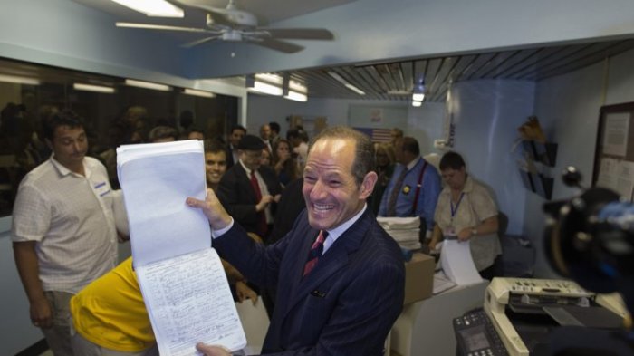 Former New York Governor Eliot Spitzer displays to the media, signatures which he delivered to the board of elections office, in New York July 11, 2013. Spitzer, who is attempting a political comeback five years after resigning from office in a prostitution scandal, is leading the race to be New York City's next comptroller, according to a poll released on Wednesday.