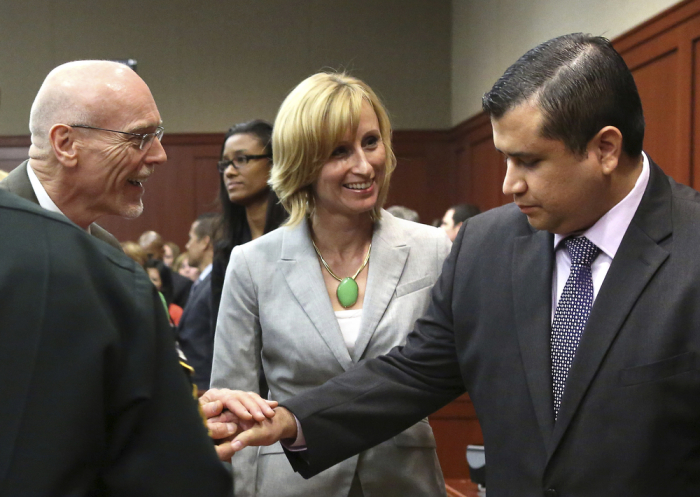 George Zimmerman (R) is congratulated by his defense team after being found not guilty in the shooting death of Trayvon Martin at the Seminole County Criminal Justice Center in Sanford, Florida, July 13, 2013. Zimmerman was acquitted of all charges on Saturday for the fatal shooting of unarmed black teenager Trayvon Martin in this central Florida town in February of last year.