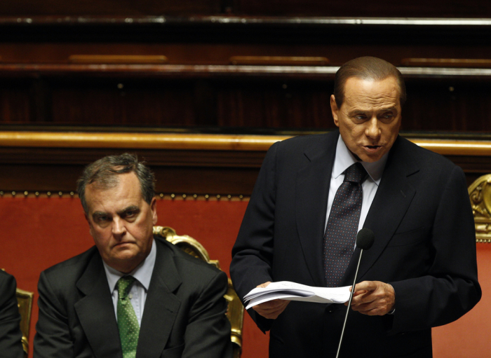 Former Italian Prime Minister Silvio Berlusconi (R) makes a speech next to Roberto Calderoli (L) during a debate at the Senate in Rome June 21, 2011. Calderoli has received huge backlash for saying Italy's first black minister Cecile Kyenge, reminds him of an ape. Berlusconi also famously described U.S. President Barack Obama as 'sun tanned.'