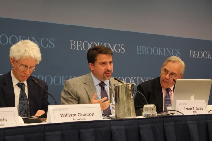 Robert P. Jones (middle), founder and CEO of Public Religion Research Institute, speaking on 'Faith, Values and the Economy, with William Galston (L) and E.J. Dionne (R) at the Brookings Institution, Washington, D.C., July 18, 2013.