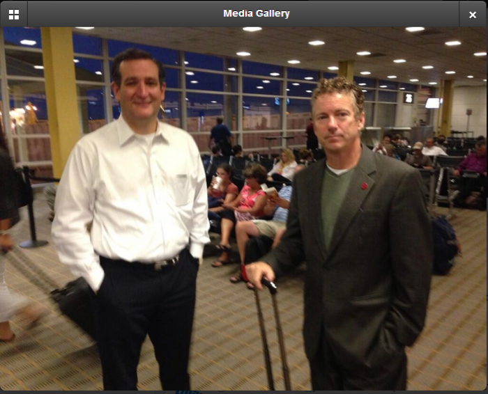 U.S. senators Ted Cruz (l) and Rand Paul wait to board a flight to Iowa last Thursday.