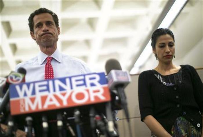 New York mayoral candidate Anthony Weiner and his wife Huma Abedin attend a news conference in New York, July 23, 2013.