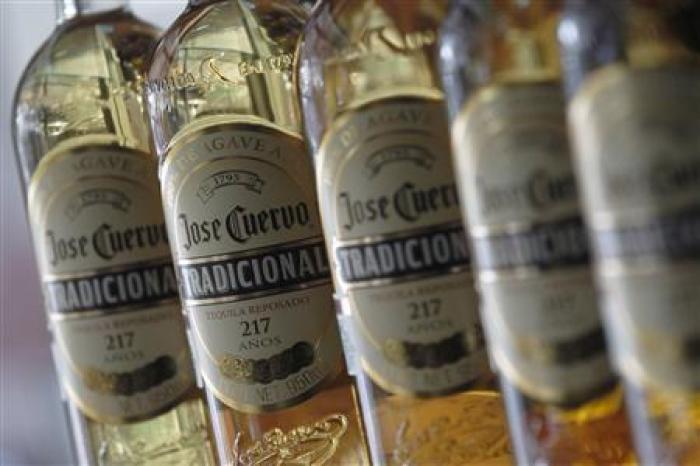 Bottles of Jose Cuervo Tequila rest on a shelf in Mexico City December 11, 2012.