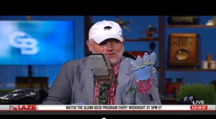Conservative political commentator Glenn Beck wears 'condom gloves' and a 'birth control nose ring' to protest against abortion.