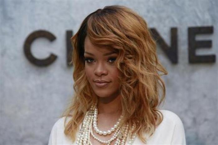 Rihanna poses before cameras in Paris