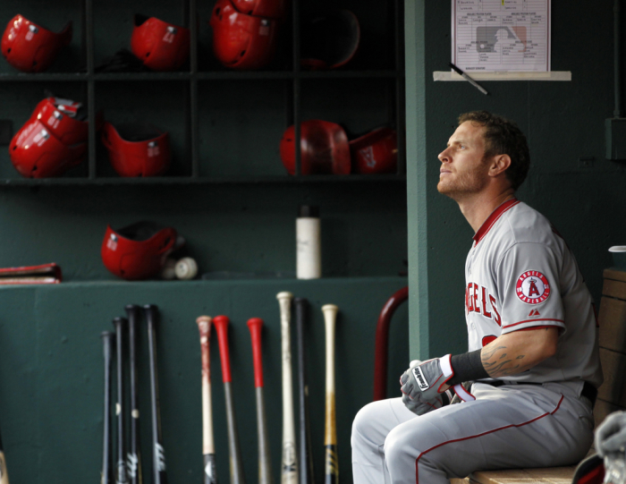 Los Angeles Angels Josh Hamilton sits in the dugout before the start of their MLB American League baseball game against the Texas Rangers in Arlington, Texas April 7, 2013.