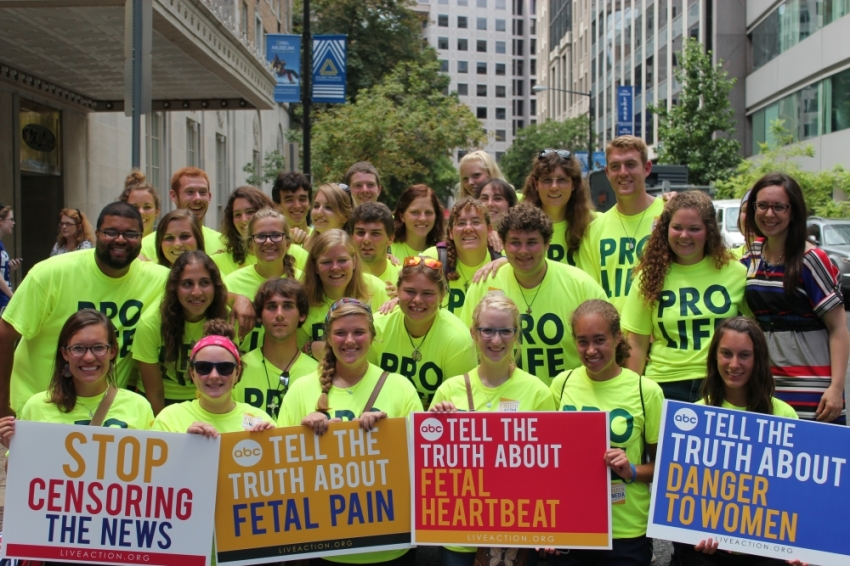 Thirty-six students, most of the forty who walked across America to protest abortion with the pro-life group Crossroads, stand in solidarity with their bright yellow shirts at the "March On Media" protest Thursday, August 8, 2013, in Washington, D.C.