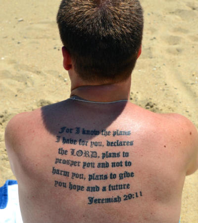 A man on the beach is seen with Jeremiah 29:11 tattooed on his back in this June 30, 2012, photo.