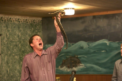 Pastor Andrew Hamblin of Tabernacle Church of God in LaFollette, Tenn., preaches while holding a snake above head.