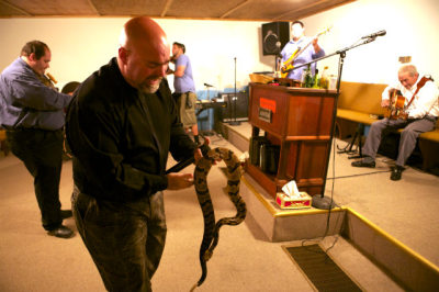 Pastor Jamie Coots of Full Gospel Tabernacle in Jesus Name church of Middlesboro, Ky., holds a snake.