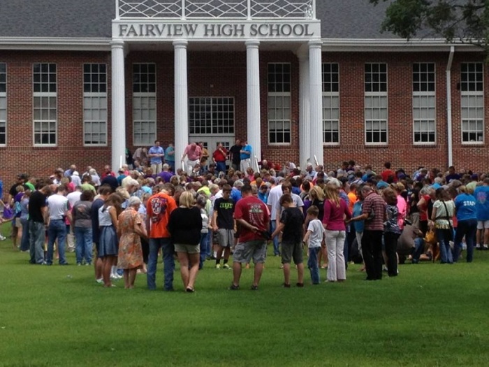 Hundreds gather at Fairview High School to pray during one stop of the Cullman County Prayer Caravan. An estimated 5,000 people participated in event that for the last three years was organized to lift up students and schools in the Alabama county school distric district in prayer, Aug. 10, 2013.