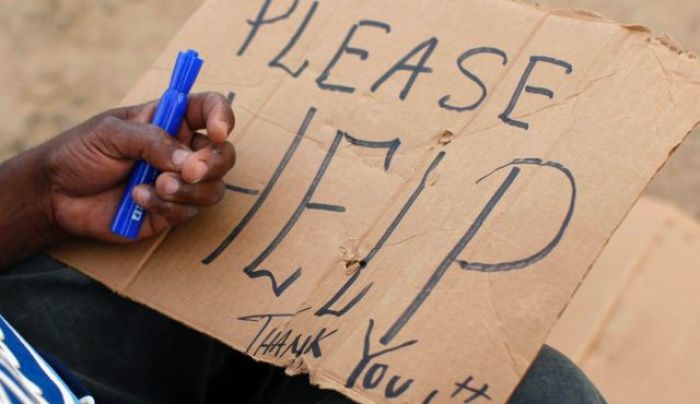 A beggar pleads for help.