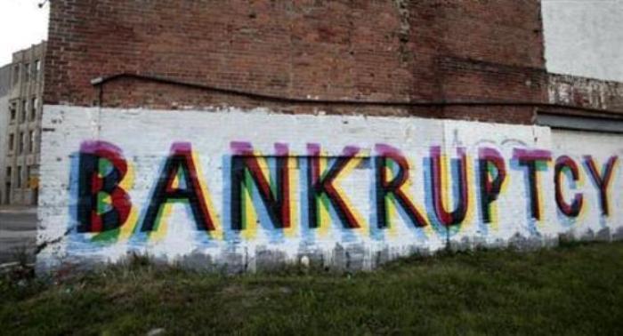 The word bankruptcy is seen painted on the side of a vacant building by street artists as a statement on the financial affairs of the city on Grand River Avenue in Detroit, Michigan, July 26, 2013.