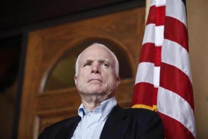 U.S. Senator John McCain (R-Ariz.), watches his colleagues speak during a news conference following their tour of the Arizona-Mexico border in Nogales, Arizona, March 27, 2013.