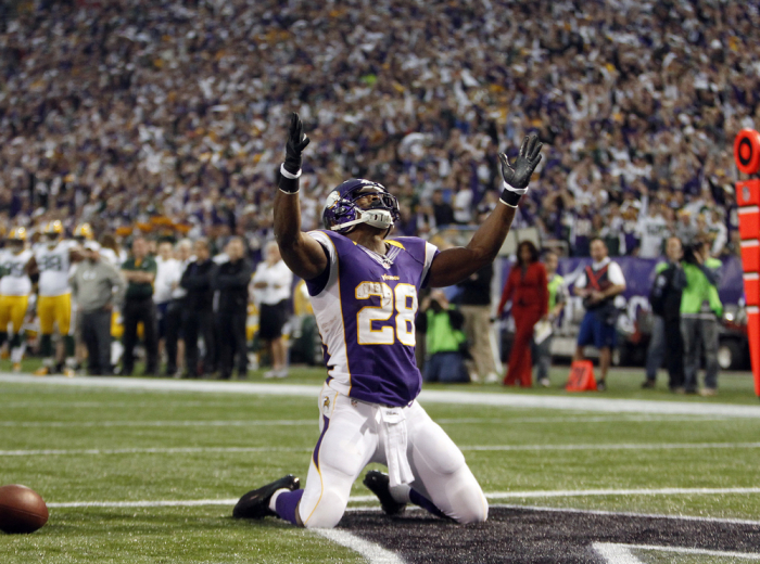 Minnesota Vikings running back Adrian Peterson (28) celebrates after he runs for a touchdown during a carry in the first half of their NFL football game against the Green Bay Packers in Minneapolis December 30, 2012.