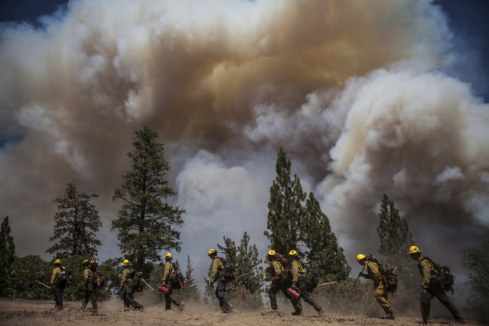 Los Angeles County firefighters hike in on a fire line on the Rim Fire near Groveland, California, August 22, 2013. The wildfire raging out of control near Yosemite National Park in northern California ballooned to nearly 54,000 acres on Thursday, more than tripling in size from the day before, forest officials said.