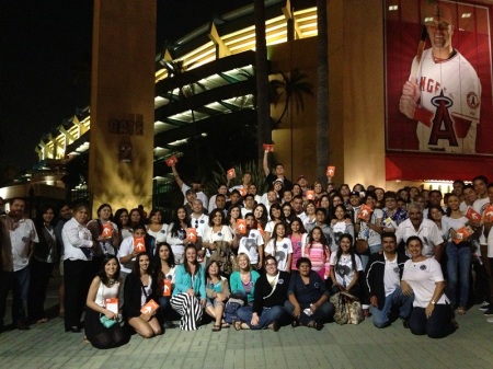 A group of 150 people gave a memorial tribute to Yesenia Eva Hernandez, who died in a car accident at age 12, by attending the SoCal Harvest with Greg Laurie after receiving an invitation to attend the stadium outreach event in Anaheim, Calif., from her parents. Nineteen of those attending are seen holding the Harvest "Start-Up" Bible that is given to those accepting an invitation to go onto the outfield at Angel Stadium and make a commitment to Jesus Christ, Aug. 24, 2013