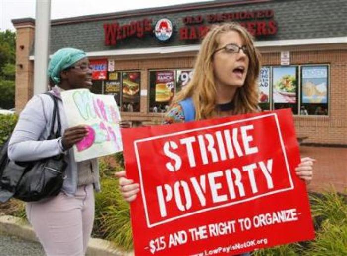Strikers march outside a Wendy's restaurant in Boston, Massachusetts August 29, 2013, as a part of a nationwide fast food workers' strike asking for $15 per hour wages and the right to form unions.