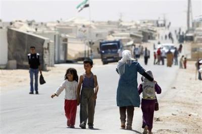 Syrian refugees walk at Al-Zaatri refugee camp in the Jordanian city of Mafraq, near the border with Syria September 1, 2013.