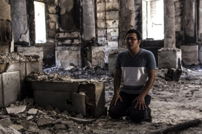 A Prince Tadros Church church member prays a day after the church was torched on August 14.