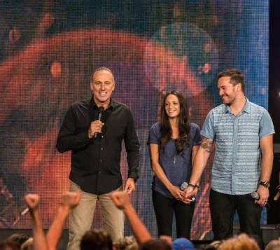 Pastor Brian Houston of Hillsong Church appears on stage with his son, Benjamin Houston, and Benjamin's wife Lucille. The pair is preparing to plant a new Hillsong Church in Los Angeles.