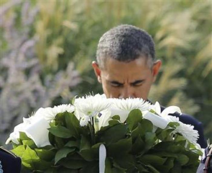 U.S. President Barack Obama lays a wreath before remembrance ceremonies for 9/11 victims at the Pentagon 9/11 Memorial in Washington September 11, 2013.