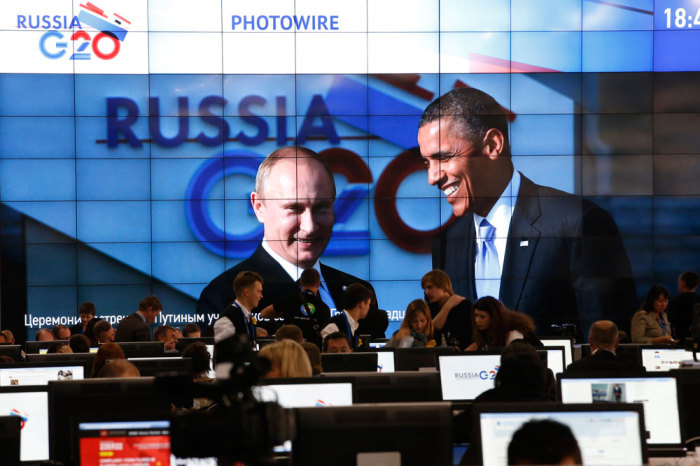 Russian President Vladimir Putin (L) and U.S. President Barack Obama are pictured on a video screen installed in the press centre of the G20 Summit in Strelna near St. Petersburg, September 5, 2013.