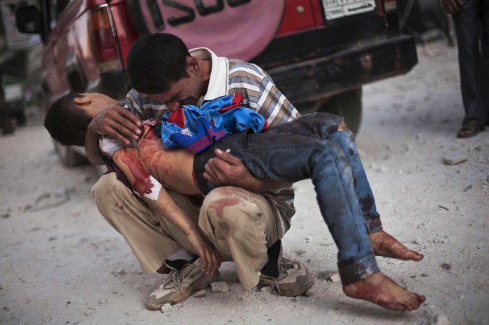 A father clutches the body of his son, who was killed by the Syrian army, in Aleppo in October 2012. There are reportedly a few hundred Muslims from Western countries who are fighting alongside the rebels to topple Syrian dictator Bashar al-Assad.