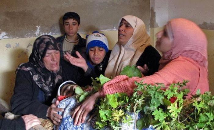 Women cry over the body of one of the five civilians killed during a Syrian Army bombardment on Al Qusayr Feb. 21, 2012.