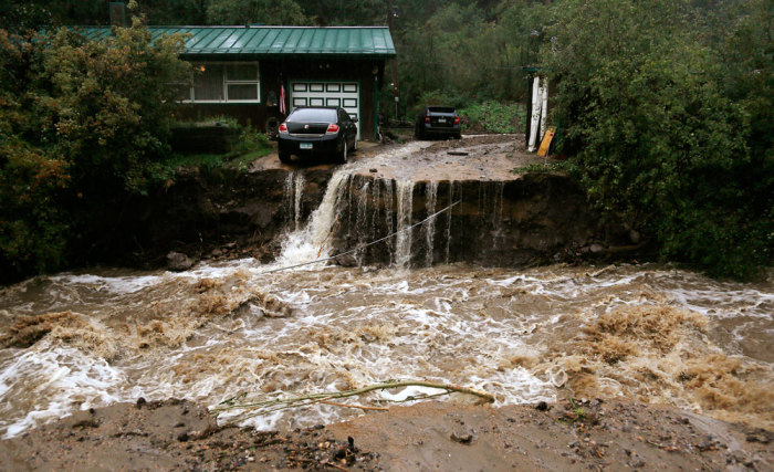 A home and car are stranded after a flash flood in Coal Creek destroyed the bridge near Golden, Colorado September 12, 2013.