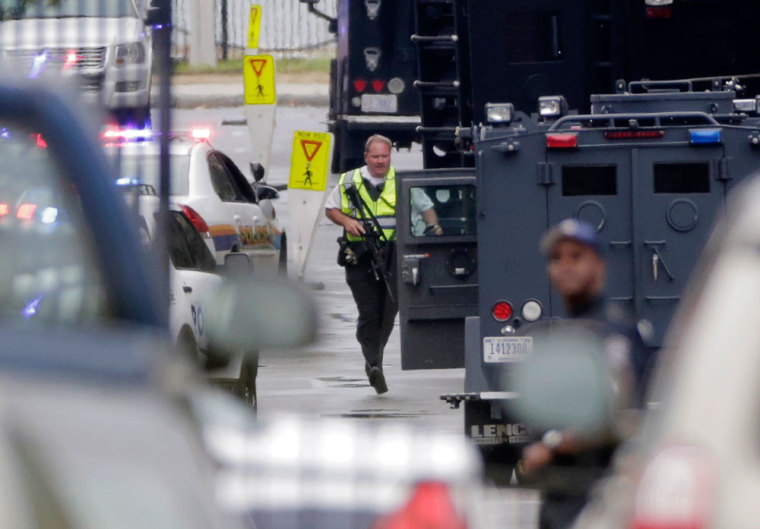 A law enforcement officer responds to the scene of a shooting at the Washington Navy Yard in Washington, September 16, 2013. Several people were killed and others injured when at least one gunman opened fire at the U.S. Navy Yard in Washington D.C. on Monday, authorities said. One Navy official said that four people had died and eight others were injured, but other officials suggested caution over those numbers saying the situation was in flux.