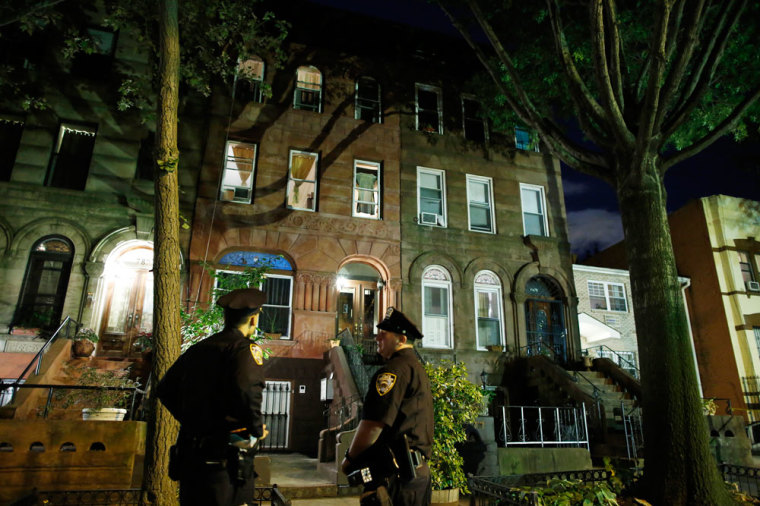Police stand guard outside the Brooklyn residence of Cathleen Alexis, mother of suspected Washington Navy Yard shooter Aaron Alexis, in New York September 16, 2013. The U.S. military veteran opened fire at the Washington Navy Yard on Monday in a burst of violence that killed 13 people, including the gunman, and set off waves of panic at the military installation just miles from the White House and U.S. Capitol. The FBI identified the suspect as Aaron Alexis, 34, of Fort Worth, Texas, a Navy contractor who had two gun-related brushes with the law.