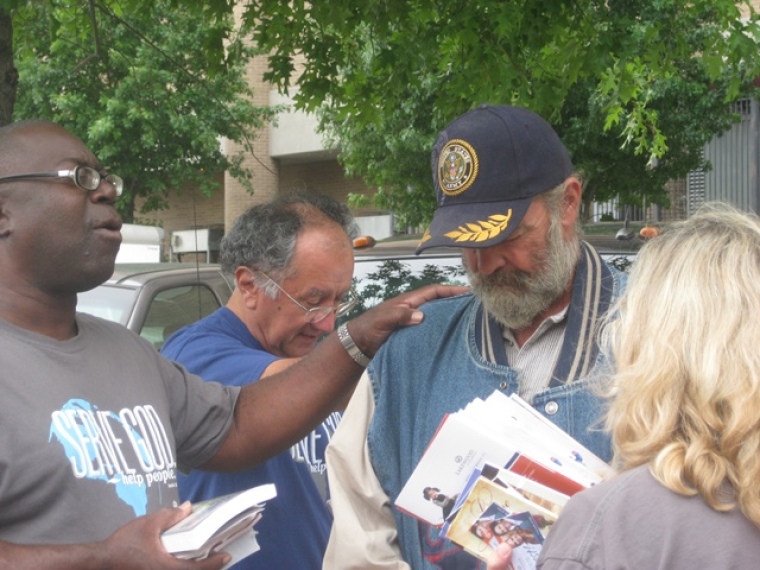 Lakewood Church's street evangelism team leaders Marcel and Donna Aguilar join in prayer for a homeless veteran in downtown Houston, Texas, on Sept. 21, 2013.