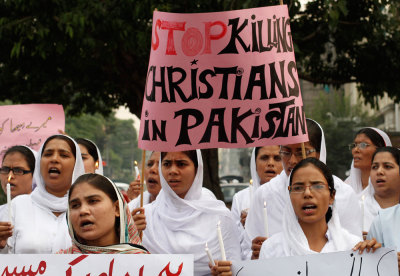 Members of the Pakistani Christian community hold a placard as they shout slogans during a protest rally in Lahore September 23, 2013. 