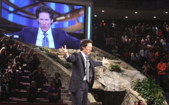 Pastor Joel Osteen leads his Lakewood Church congregation in prayer in Houston, Texas, on Sept. 22, 2013.