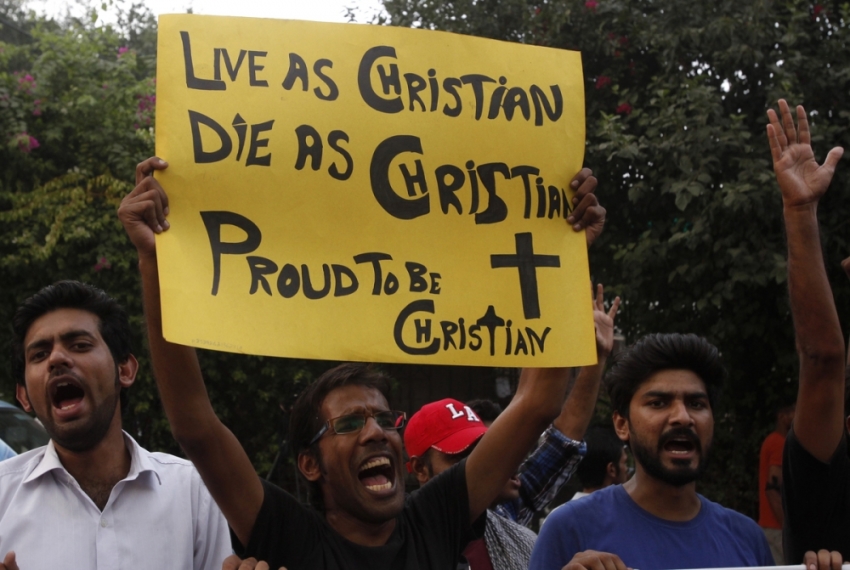 A member of the Pakistani Christian community holds a placard as he shouts slogans during a protest rally to condemn Sunday's suicide attack in Peshawar on a church, with others in Lahore September 23, 2013. A pair of suicide bombers blew themselves up outside the 130-year-old Anglican church in Pakistan after Sunday mass, killing at least 85 people in the deadliest attack on Christians in the predominantly Muslim country.