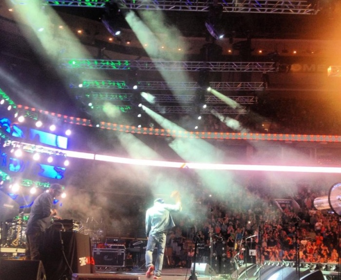 Lecrae makes an entrance on stage at Harvest America to begin his rap set, Sept. 28, 2013.