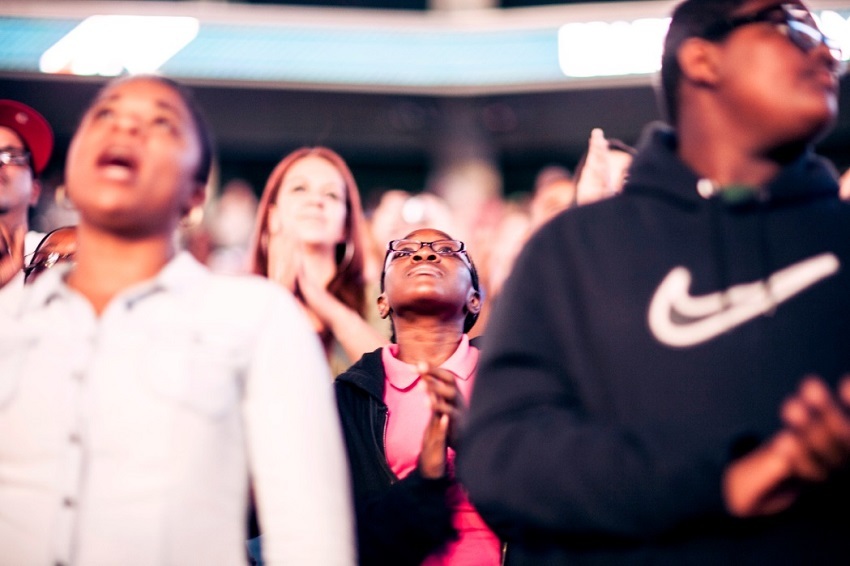 Young woman is part of more than 17,500 attending first night of Harvest America at Wells Fargo Center in Philadelphia, Sept. 28, 2013.