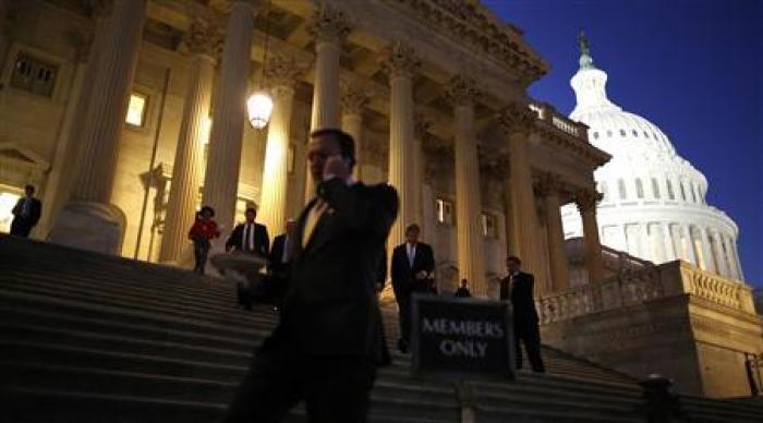 Members of the Republican-controlled U.S. House of Representatives depart after a procedural vote leading up to a late-night session to deal with a budget showdown with the Democratic-controlled U.S. Senate, at the U.S. Capitol in Washington, September 30, 2013.